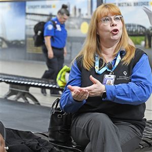Patti Getty with the Airport Authority talks about her job on the help desk at Pittsburgh International Airport on Tuesday, Oct. 7, 2025. 