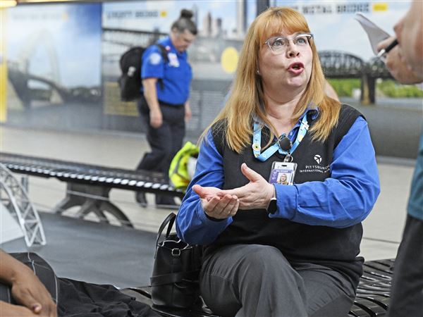 Patti Getty with the Airport Authority talks about her job on the help desk at Pittsburgh International Airport on Tuesday, Oct. 7, 2025. 