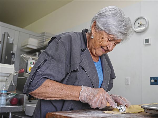 Carla Calvitti, 85, cuts cheese ravioli at Tillie’s Restaurant in McKeesport in June 2024.