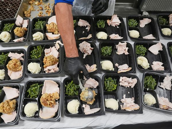 A volunteer prepares meals at the Philabundance Community Kitchen in Philadelphia, Thursday, Oct. 30, 2025.