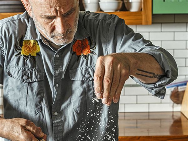 Philadelphia chef Marc Vetri finished a pan of cacio e pepe with grated Parmesan cheese.