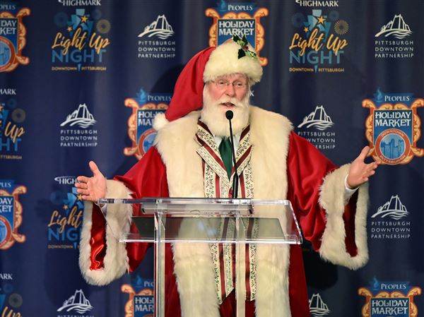 Santa Claus makes an appearance during the Pittsburgh Downtown Partnership’ s holiday season event announcement press conference at Heinz Hall Downtown Thursday.  