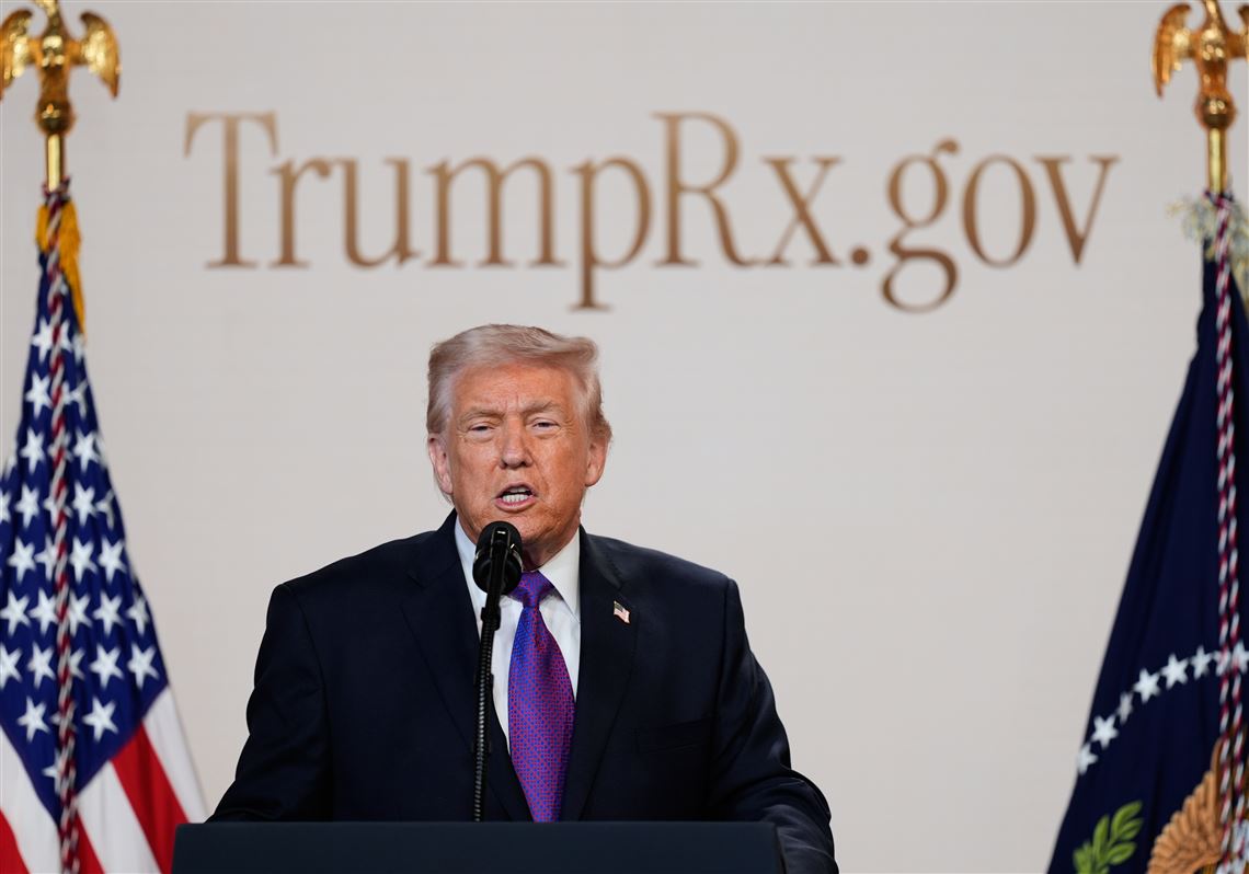 President Donald Trump speaking at podium during TrumpRx.gov launch event with official backdrop