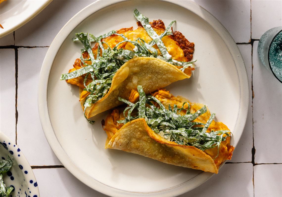 These crispy Buffalo chicken tacos come with collard slaw and ranch dressing