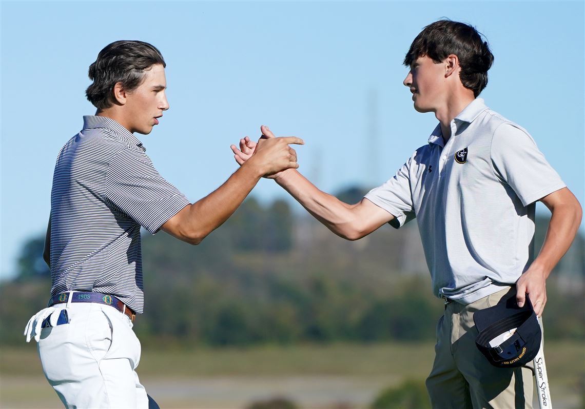 Shady Side Academy’s Alex Avi, left, shakes hands with Quaker Valley’s Joseph Kamnikar after parring the 18th hole during the WPIAL Class 2A boys golf championship, Tuesday, Oct. 6, 2026, at Oakmont Country Club.